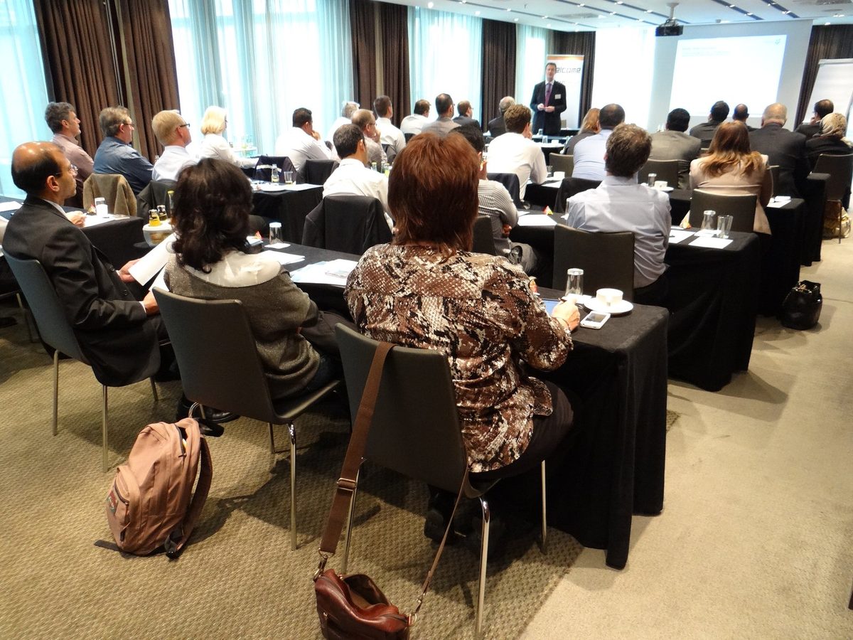 A full seminar room of delegates facing a presenter at a previous Zenith Group event